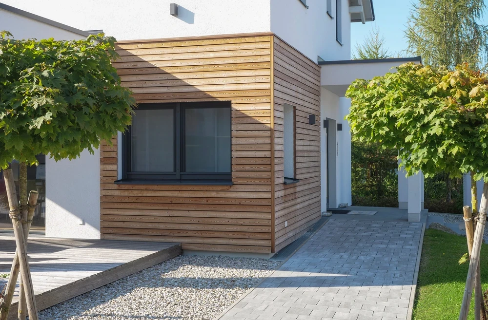 Façade d'immeuble résidentiel contemporain avec bardage bois horizontal de teinte claire